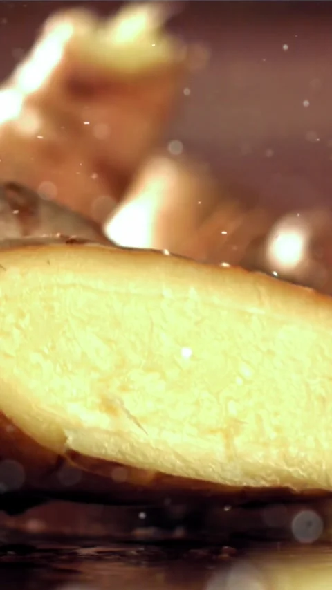 A knife cuts through fresh ginger. Filmed on a high-speed camera at 1000 fps Stock Footage 335322565