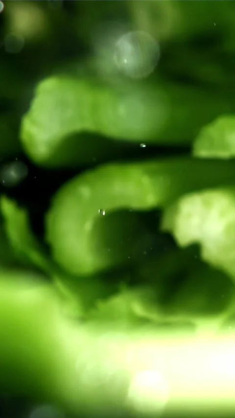The knife cuts through the fresh sprinkled celery. Filmed on a high-speed camera Stock Footage 335317897