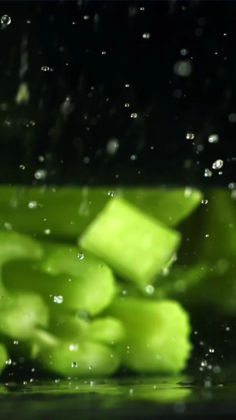 The knife cuts through the fresh sprinkled celery. Filmed on a high-speed camera Stock Footage 335322975