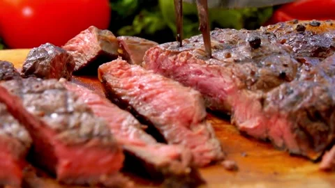 Knife cuts through hot roast, Witness the perfect marbling of the roast Stock Footage 336581777