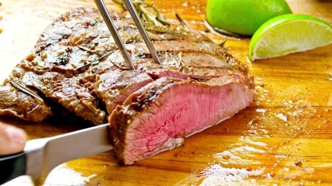 Knife cuts through hot roast, Witness the perfect marbling of the roast Stock Footage 336582123