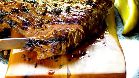 Knife cuts through hot roast, Witness the perfect marbling of the roast Stock Footage 336582142