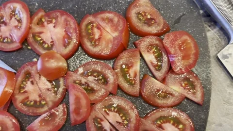 A knife is on a cutting board with a tomato on it Stock Footage 286309156