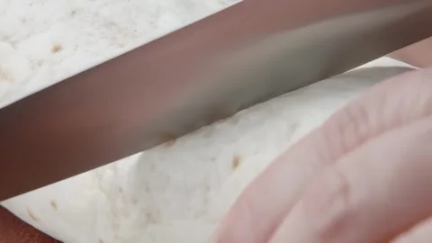 Knife cutting a cooked burrito Stock Footage 291199561