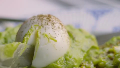Knife Cutting in to Fresh Soft Boiled Eggs with Golden Yolk with Smashed Stock Footage 341605635