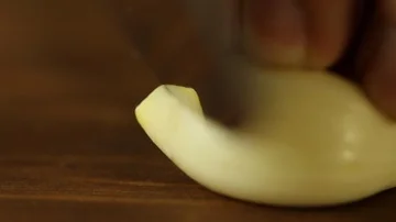 Knife Cutting a Garlic Stock Footage 86136426