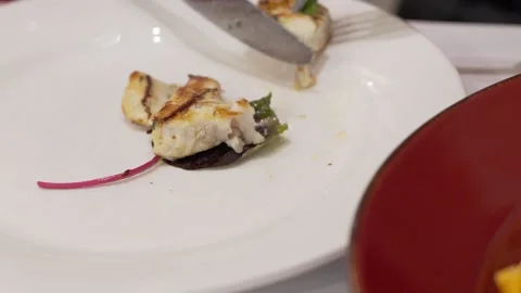 Knife Cutting Grilled Chicken on White Plate Stock Footage 324692899