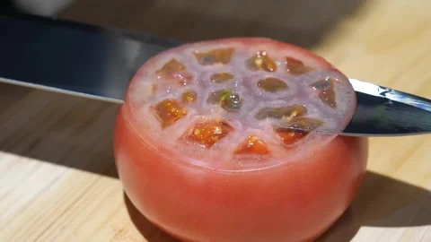 Knife Cutting a Paper Thin Slice from a Ripe Tomato Stock Footage 340900689