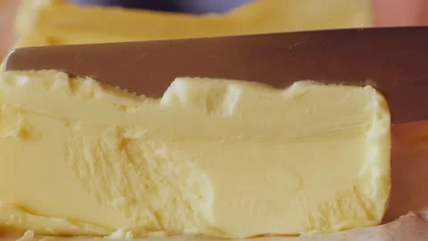 Knife cutting of a piece of butter Stock Footage 205548344