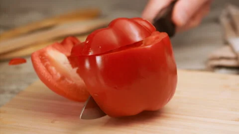 Knife cutting red bell pepper in slow motion Stock Footage 152905185