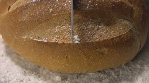Knife cutting rustic bread loaf Video stock 137072750
