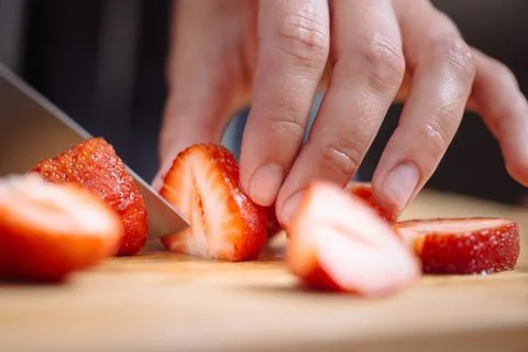 Knife cutting a strawberry Stock Photos