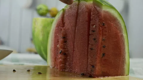 Knife cutting through watermelon and removing slice - slow motion closeup shot Stock Footage 341213041