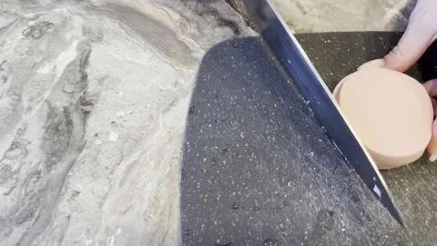 A knife is cutting a tomato on a counter 스톡 동영상 282298147