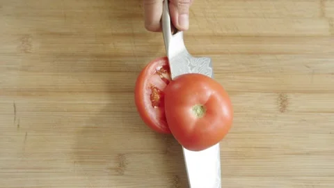 Knife Cutting Tomato in slow motion Stock Footage 169535185