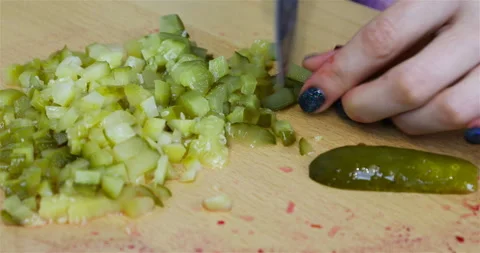 Knife edge cuts cucumber slices into cubes Stock Footage 101850664