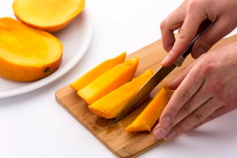 Knife finished cutting off a fourth mango chip Stock Photos