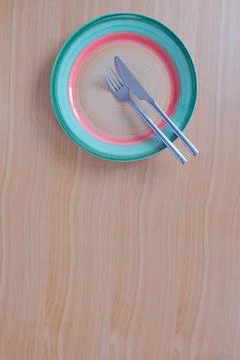 Knife, fork and plate on a table viewed from above Fotos de archivo