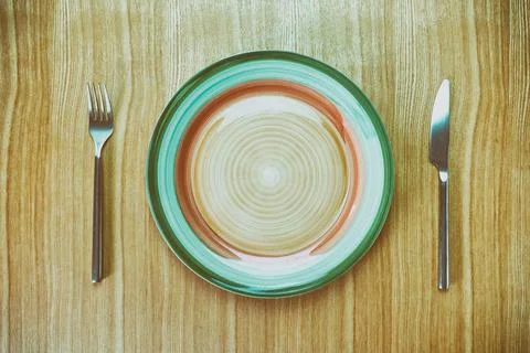 Knife, fork and plate on a table viewed from above Fotos de archivo