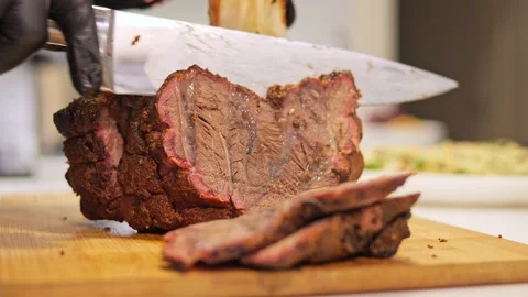 Knife gracefully carves through roasted meat. Experience the tantalizing aroma Stock Footage 272956872
