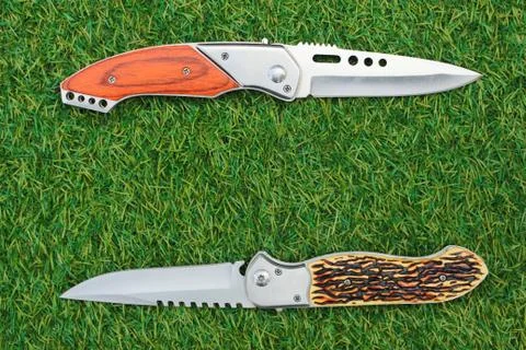 Knife on green grass background Stock Photos