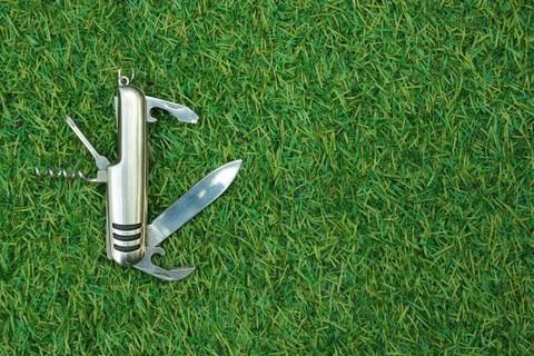 Knife on green grass background Stock Photos