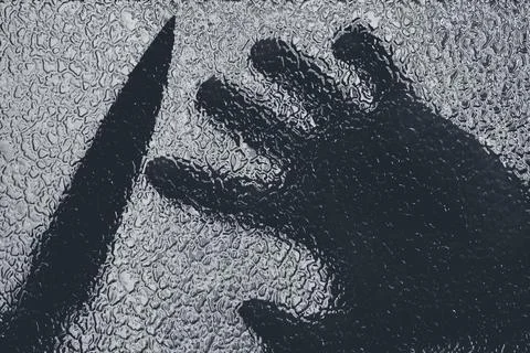 Knife in hand. Aggressive tin attack. Hacking attempt. The criminal behind the Stock Photos