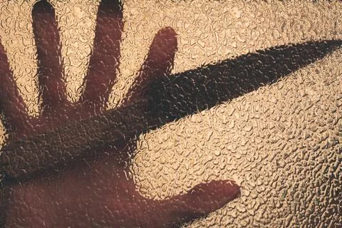 Knife in hand. Aggressive tin attack. Hacking attempt. The criminal behind the Stock Photos