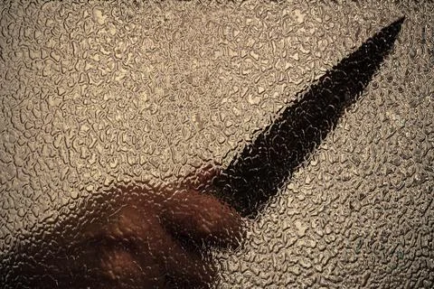 Knife in hand. Aggressive tin attack. Hacking attempt. The criminal behind the Stock Photos