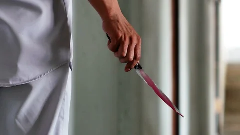 A knife in a hand of the man inside an abandoned house. Stock Footage 118241912