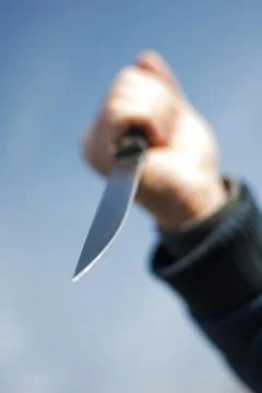 Knife in the hand of a man. Stock Photos