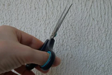 Knife in human hand opened for cutting on light background Stock Photos
