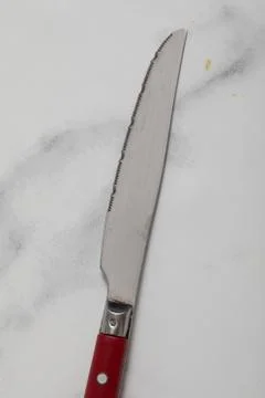 Knife isolated on white background with red handle. Stock Photos