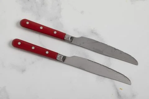 Knife isolated on white background with red handle. Stock Photos