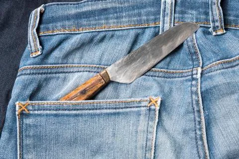 Knife in jean Stock Photos