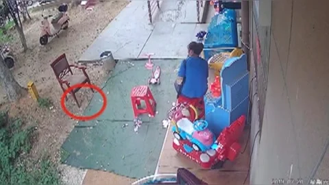 Knife lands upright beside mother and daughter after falling from residential Stock Footage 272920853