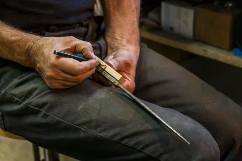 Knife maker drawing marking on knife handle Photos
