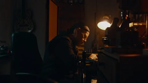 Knife maker sitting at desk Stock Footage 275443511