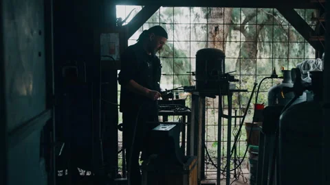 Knife maker in workshop using blow torch Stock Footage 275440283
