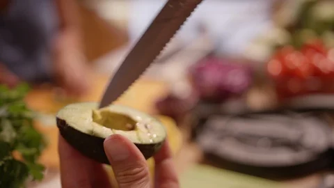 Knife making slices into half of an avocado Video stock 124225613