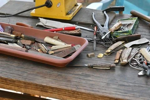 Knife making tools arranged on a workbench Stock Photos