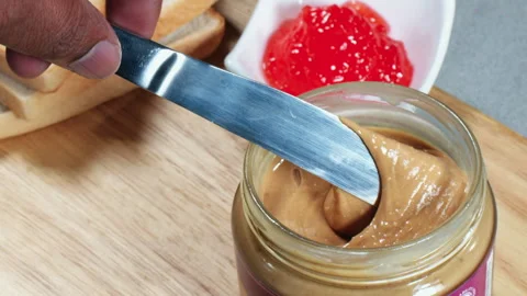Knife In the Peanut Butter jar Stock Footage 248686684