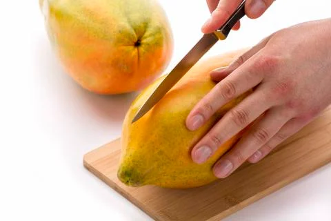 Knife Positioned For A First Cut Through A Papaya Stock Photos