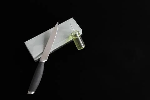 Knife rests on whetstone 스톡 사진