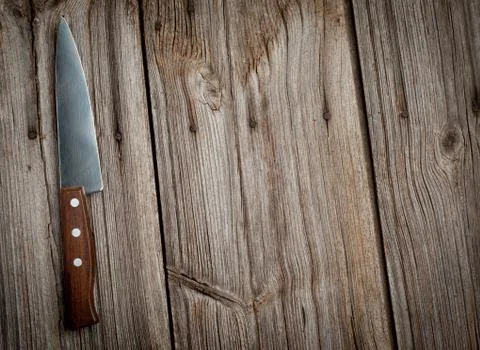 Knife on rustic kitchen table with copy space Foto stock