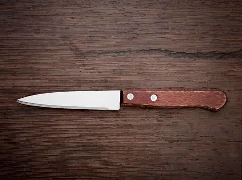 Knife on rustic kitchen table Stock Photos