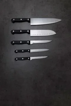 Knife set on a dark gray table Stock Photos