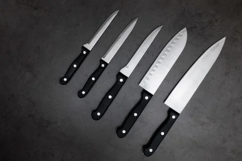 Knife set on a dark gray table Stock Photos