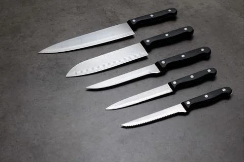 Knife set on a dark gray table Stock Photos