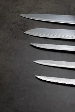 Knife set on a dark gray table Stock Photos